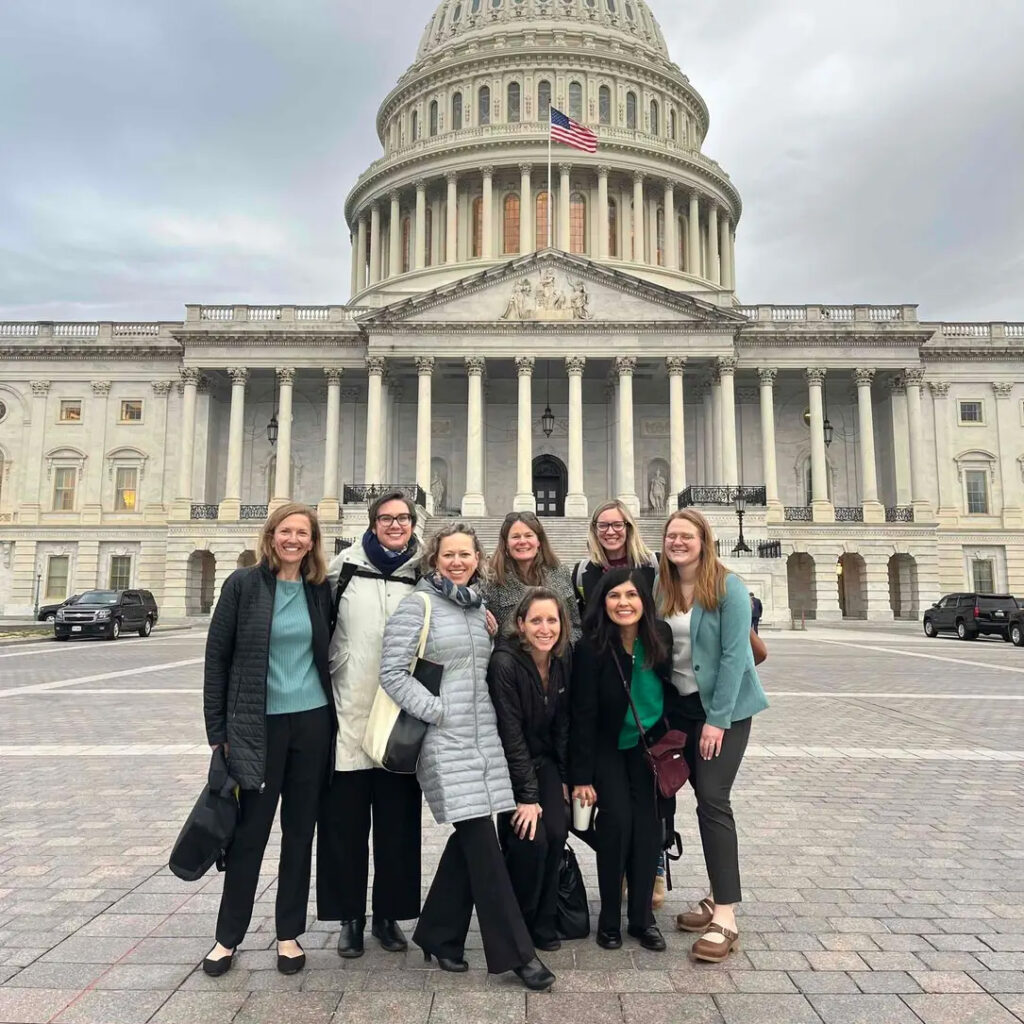 Mountain Mamas pose in front of the capitol building in D.C.
