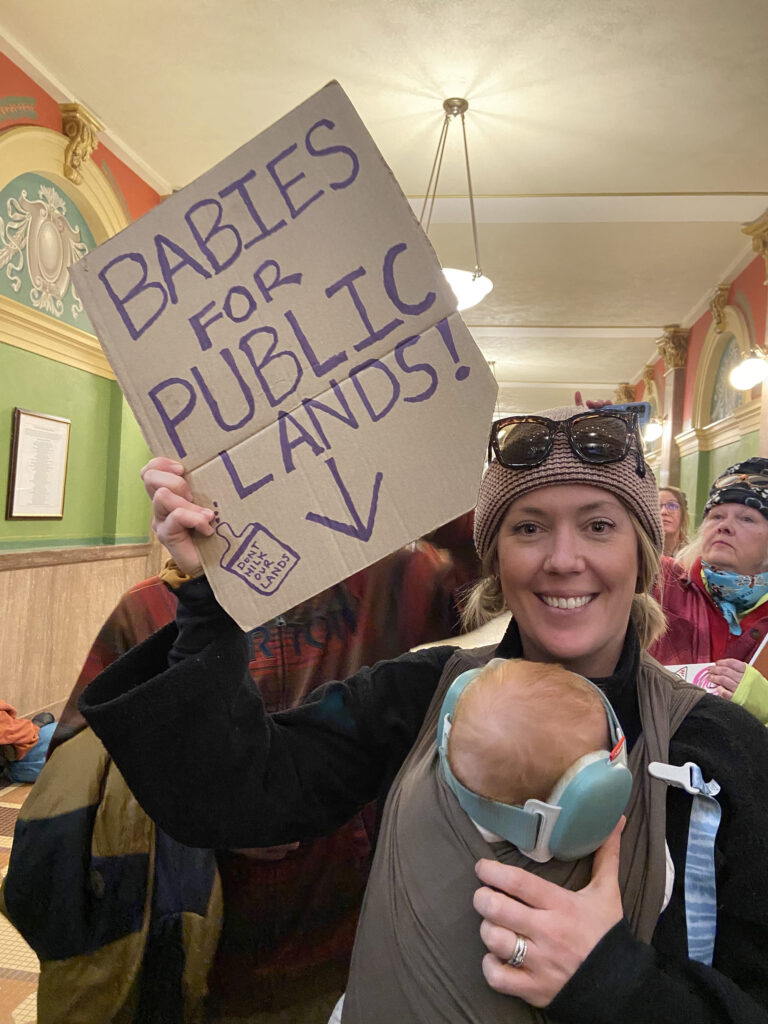 Mama with baby campaigning for public lands